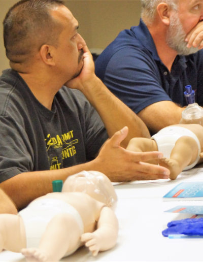 Photo of students with infant mannequin