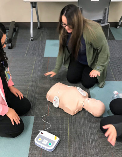 Photo of students learning AED best practices