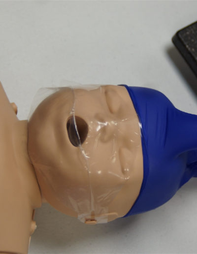 Image of infant cpr mannequin with glove on head