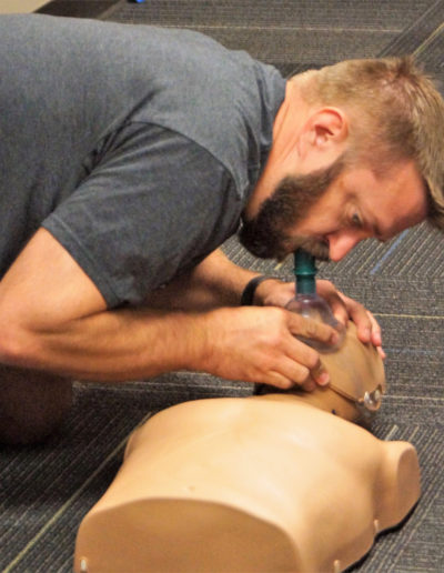 Image of a closeup of a student learning to give a breath