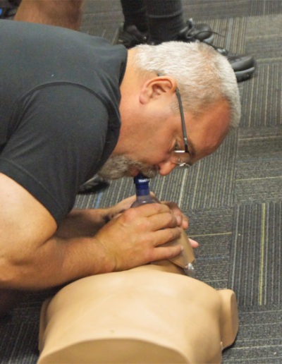 Picture if a student practicing breaths with an adult manikin