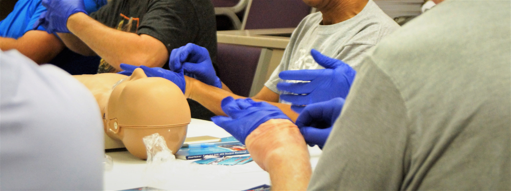 Picture of students taking disposable medical gloves off