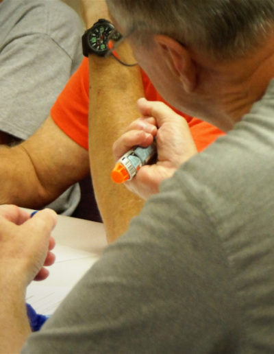 Photo of students receiving epinephrine pen training