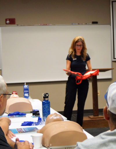 Photo of instructor showing first aid kit contents
